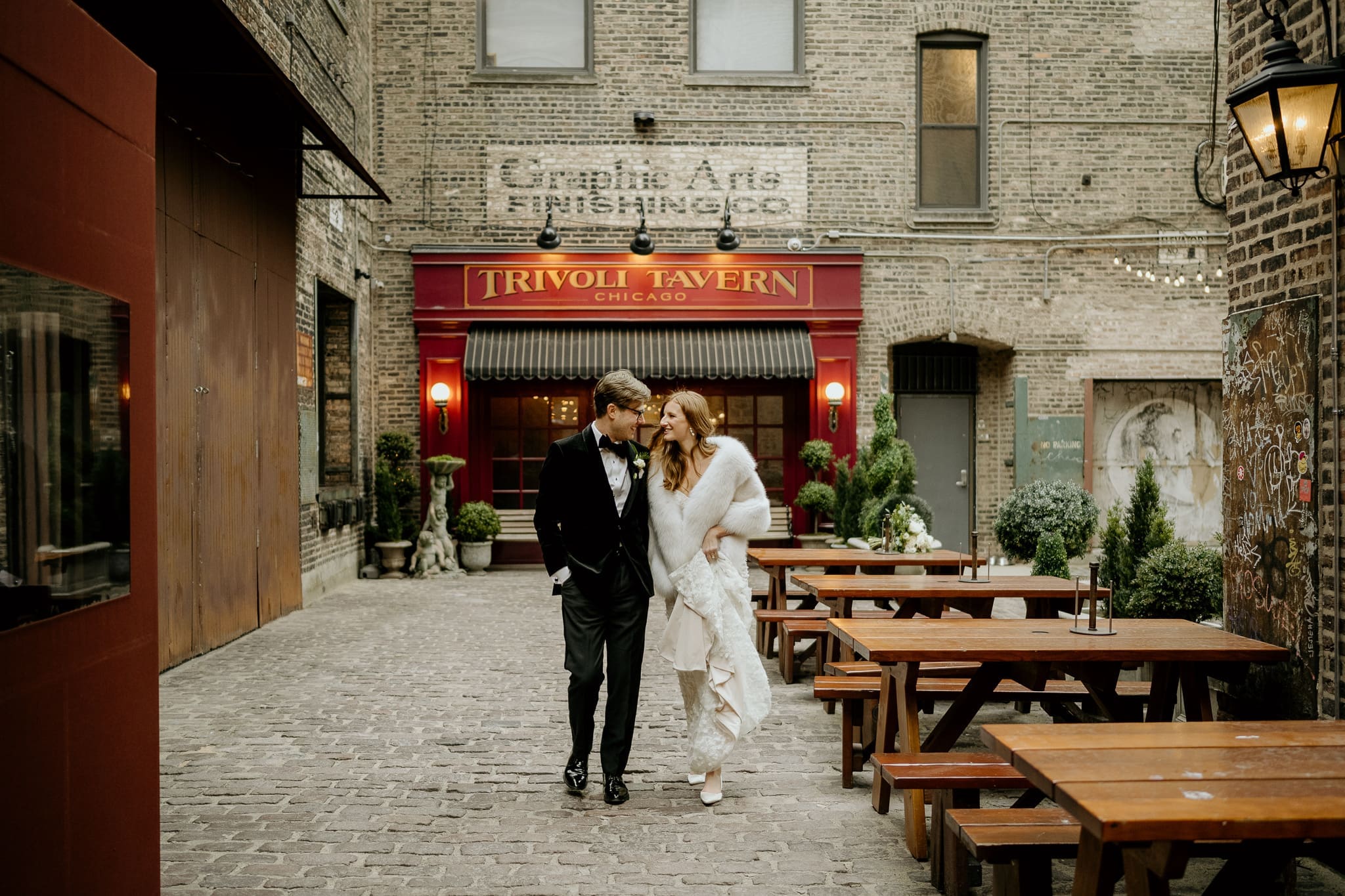 Molly and Alec outside Trivoli Tavern during their winter wedding in Chicago.